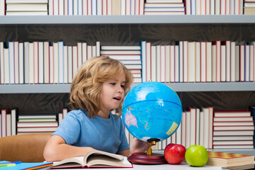 Fototapete - Child from elementary school with book. Little student, clever nerd pupil ready to study. First time to school. Concept of education and learning.