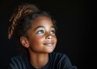 © jiawei - little African American girl with colorful sweatshirt in black background