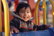 portrait of a smiling hispanic boy toddler happy child wearing blue sweat intense look on a playground closeup shot of a young latino american outdoors curiousity sunlight laughing happiness cheerful