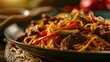 Stir-fried noodles with beef and vegetables on wooden table, closeup