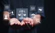 © Pakin - Legal advice business concept. Person holding virtual law icon for business legal advice, Labor law, Lawyer, Attorney at law.
