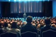 © Bussakon - Bustling scene of crowded auditorium filled with eager audience all facing prominent stage set for significant event or performance dynamic setting captures of public engagement and entertainment
