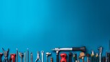 Fototapeta  - Various handy tools arranged on bright blue background with copy space, concept of DIY, home improvement, and repair