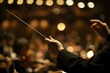 a conductor holding a string in front of a orchestra