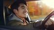 © liliyabatyrova - Close-up of a beautiful happy smiling Asian man driving a car against the background of autumn nature. Car purchase and rental, travel and vacation concepts.