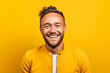 portrait of a man smiling in front of yellow background