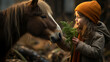 A child feeding a carrot to a horse