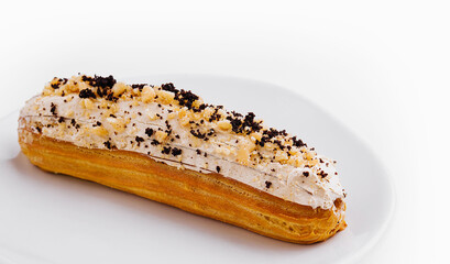 Wall Mural - Eclair with cream and chocolate on plate