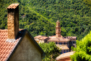 Wall Mural - The Church Tower Dominating the Beautiful Old Village of Omessa on Corsica, France