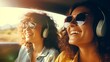 Two young women listen to songs with headphones and sing, dance in the car during the trip. Best friends have fun together, Travel at sunset.