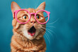 surprised ginger cat with an open mouth wearing round glasses with a pink frame on a blue background
