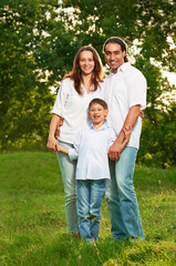 Wall Mural - Intarnational family portrait in the park on sunset