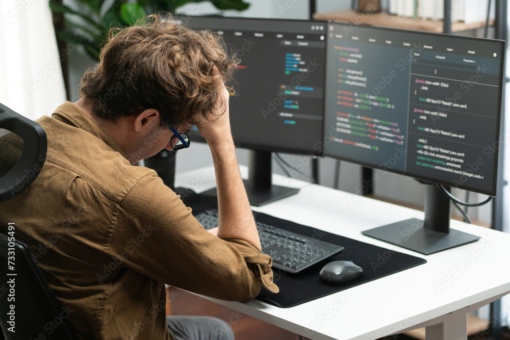 IT developer working online software development on pc monitors at ...