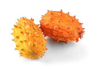 Poster - Kiwano fruit or Horned melon close up. Fresh and juicy African horned cucumber or jelly melon, hedged gourd liana whole exotic fruits closeup, isolated on white background. 