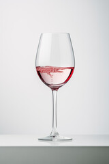 glass of rose wine on white background