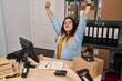 © Krakenimages.com - Young beautiful plus size woman ecommerce business worker stretching arms at office