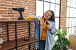 © Krakenimages.com - Young beautiful plus size woman smiling confident repairing shelving at new home