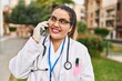 © Krakenimages.com - Young beautiful plus size woman doctor smiling confident talking on smartphone at park