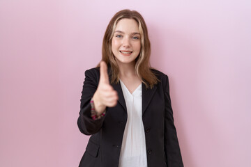 Canvas Print - Young caucasian business woman wearing black jacket smiling friendly offering handshake as greeting and welcoming. successful business.