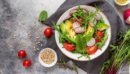 Wall Mural - diet menu healthy salad of fresh vegetables tomatoes avocado arugula radish and seeds on a bowl vegan food flat lay banner top view