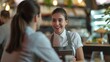 Smiling waitress wear apron hold tablet take order talk to client serving restaurant, Good customer service.