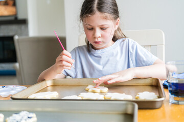 Wall Mural - Little Girl Spells 'Sorry' on Iced Sugar Cookies