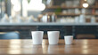 Simple Elegance: White Mugs in Bright Cafe Interior

