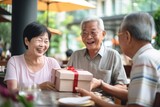 Fototapeta  - Surprising Asian couple celebrates fathers day with elderly father.