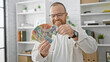© Krakenimages.com - Cheerful caucasian business man confidently counting australian dollars at office, radiating success and happiness