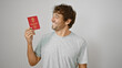 Jovial young man proudly flaunting his norwegian passport, basking in pure joy and confidence, isolated on a white background