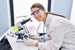 © Krakenimages.com - Young caucasian woman scientist using microscope at laboratory