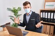 © Krakenimages.com - Young man business worker wearing medical mask working at office