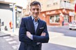 © Krakenimages.com - Young man business worker smiling confident standing with arms crossed gesture at street
