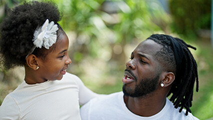 Sticker - African american father and daughter smiling confident hugging each other at park