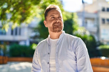 Poster - Young caucasian man smiling confident looking to the sky at park