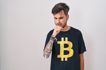 Sticker - Young hispanic man with tattoos wearing bitcoin t shirt feeling unwell and coughing as symptom for cold or bronchitis. health care concept.