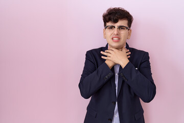 Poster - Young non binary man with beard wearing suit and tie shouting and suffocate because painful strangle. health problem. asphyxiate and suicide concept.