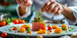 Chef Garnishing Fresh Tuna and Vegetable Dish in Fine Dining Restaurant
