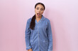 © Krakenimages.com - Young arab woman wearing blue pajama in shock face, looking skeptical and sarcastic, surprised with open mouth