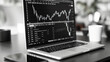black and white image of stock analytics on laptop 