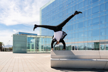 Flexible and cool businessman doing acrobatic trick