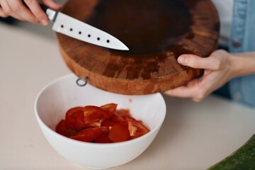 Wall Mural - Fresh, Healthy Vegetable Salad: A Female Chef's Delightful Meal Preparation on a Wooden Board