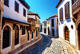 Fototapeta  - Ancient eastern narrow streets of the beautiful Kukort Muslim city on the shores of the Mediterranean Sea, tourist attractions in Turkey,
