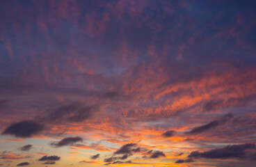 Wall Mural - Beautiful fiery orange sunset sky with dark textures clouds