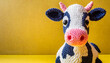 Crocheted cow toy vibrant backdrop, handcrafted and adorable, copyspace on a side