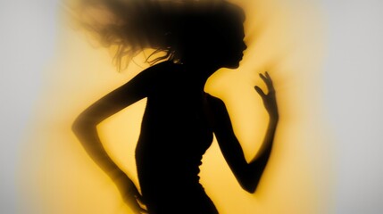 Wall Mural - Female blurred silhouette on a yellow background. Elegant outline of a woman in motion out of focus