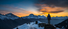 Adventure Dreamscape. Girl On Top Of A Rocky Mountain Cliff Overlooking A Beautiful Dramatic Landscape During Sunset Landscape With High Peaks And Foggy Valley Under Vibrant Colorful Evening Sky.