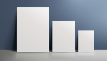 Wall Mural - A realistic canvas mockup with blank space, three canvases by the wall on navy blue background, perfect for posters, art projects, paintings, presentations, marketing materials. Not AI.