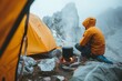 Amidst the wintry mountain fog, a lone adventurer rests by the crackling campfire, surrounded by their hiking equipment and bundled up in warm clothing, finding solace in the quiet embrace of the gre