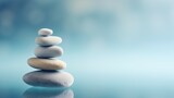 Fototapeta Desenie - Zen Stone Stack on a Serene Blue Gradient Background. Balance and Harmony Concept. Stones symbolising peace and calm energy.